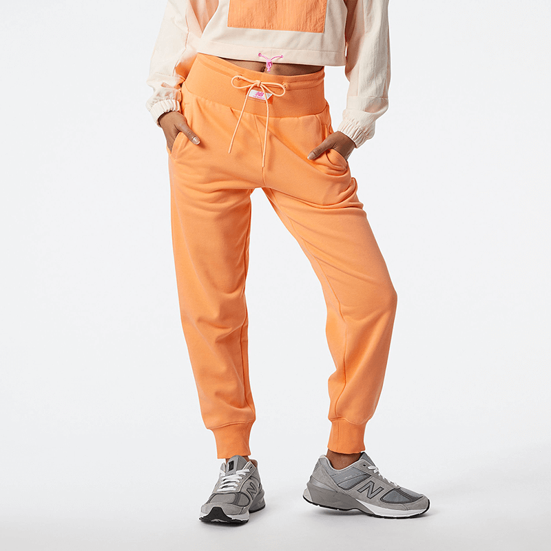Spodnie New Balance WP21503PGZ – pomarańczowe